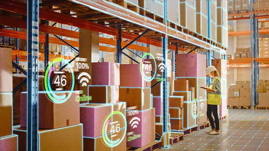 A warehouse worker checking stock with digital inventory overlays on the racking